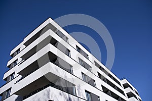 Exterior of new apartment buildings on a blue cloudy sky background.