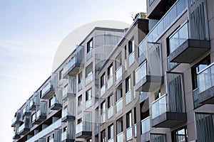 Exterior of new apartment buildings on a blue cloudy sky background.