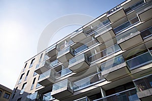 Exterior of new apartment buildings on a blue cloudy sky background.