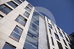 Exterior of new apartment buildings on a blue cloudy sky background.