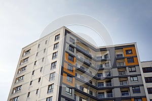 Exterior of new apartment buildings on a blue cloudy sky background.