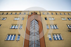 Exterior of new apartment buildings on a blue cloudy sky background.