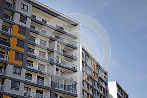 Exterior of new apartment buildings on a blue cloudy sky background.