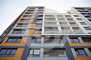 Exterior of new apartment buildings on a blue cloudy sky background.