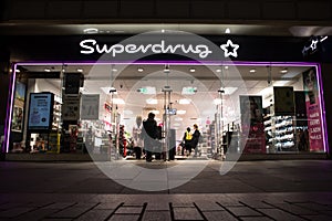 Exterior Night Shot of Illuminated entrance to Superdrug Store