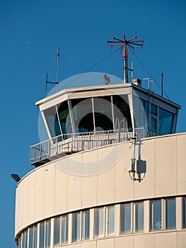 An exterior of an old and abandoned air traffic control tower from the 1930s\'. VHF radio antennas on top of the roof.