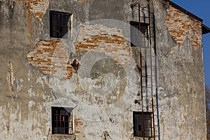 Exterior of old brick building with rusted fire escape