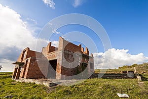 Exterior of an old building under construction. Orange brick walls in a new house.