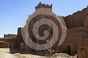 Exterior of an old ruined adobe building with tower in Agdz, Morocco