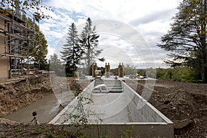 Exterior old villa under construction. The garden has disappeared and the pool is already being excavated