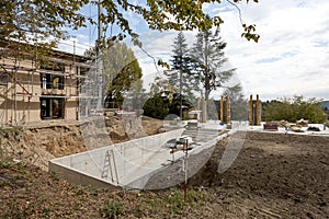 Exterior old villa under construction. The garden has disappeared and the pool is already being excavated