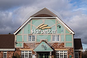 Exterior outside shot of Harvester Family Restaurant Pub Chain showing entrance and company sign and logo