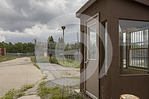 Exterior of prison guard house with overgrown yard