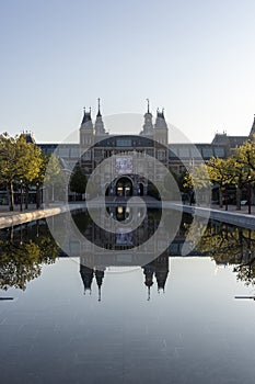 Exterior of the Rijksmuseum reflected in the water, early morning in Amsterdam, Noord-Holland, The Netherlands