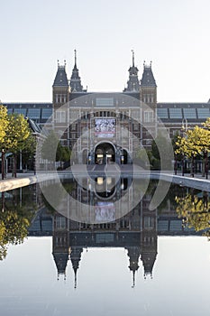 Exterior of the Rijksmuseum reflected in the water, early morning in Amsterdam, Noord-Holland, The Netherlands