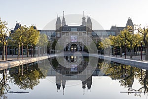 Exterior of the Rijksmuseum reflected in the water, early morning in Amsterdam, Noord-Holland, The Netherlands