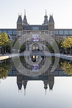 Exterior of the Rijksmuseum reflected in the water, early morning in Amsterdam, Noord-Holland, The Netherlands