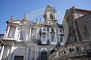 Exterior of S. Francisco church. Bell tower of a church and statues of saints on the roof. Blue sky