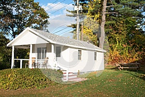 Exterior of a small hioliday cabin in a park in autumn