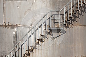 Exterior stairs of refinery industrial storage tank.