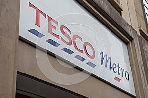 Exterior of Tesco Metro supermarket and grocery shop.  Showing logo, sign, signage and branding of company branches