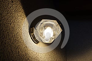 Exterior tungten bulb lamp on wall by night