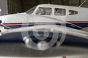 Exterior View of Aircraft and Woman Pilot With Headset in the Cockpit