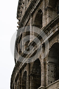 Exterior view of the ancient Colosseum in Rome, Italy, against a cloudy sky