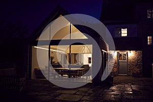 Exterior View Of Beautiful Kitchen Extension At Night photo