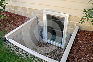 Exterior view of an egress window in a basement bedroom. These windows are required as part of the USA fire code for basement