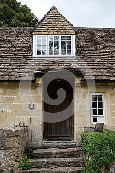 Exterior view and front door of an old cottage house