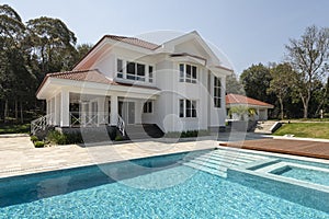 Exterior view of a house with swimming pool and moving deck