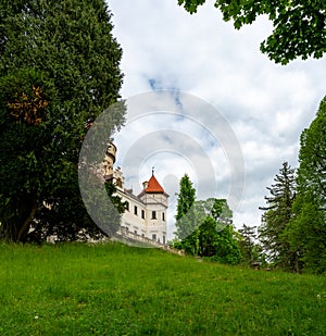Exterior view of Konopiste Castle, former residence of Archduke Franz Ferdinand of Austria, surrounded by lush greenery and photo