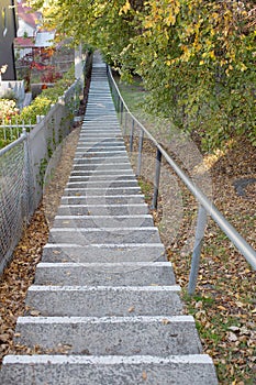 Large concrete steps moving up an incline between two streets photo