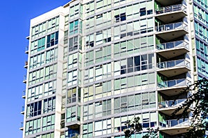 Exterior view of modern multifamily residential building with large glass windows; San Francisco, California