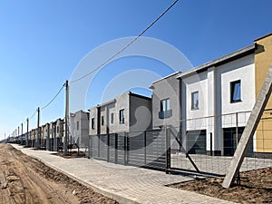 Exterior view of a modern townhouse. The concept of outdoor buildings of multi-apartment residential townhouses