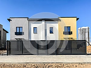 Exterior view of a modern townhouse. The concept of outdoor buildings of multi-apartment residential townhouses