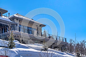 Exterior view of a mountain home with blue sky background on a sunny winter day