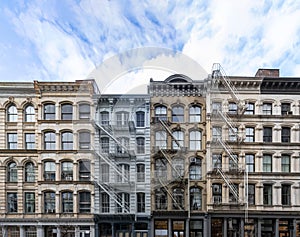 Exterior view of old apartment buildings in the SoHo neighborhood of Manhattan in New York City with empty blue sky