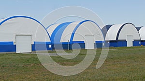 Exterior view of a series of hangars for small aircraft at an airfield outside the city