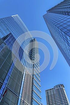 Exterior view of towering apartments with glass facade against clear blue sky