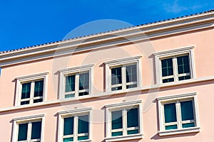 Exterior view of typical new mid-rise multifamily residential building without balcony.