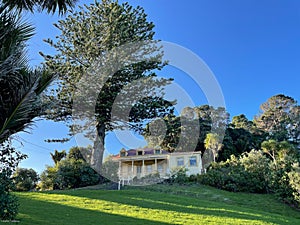 Exterior view of Vaughan Historic Homestead in a sunny day, Long Bay Regional Park, Auckland, New Zealand