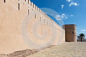 Exterior view of wall and tower of Sunaysilah fort in town of Sur, Oman