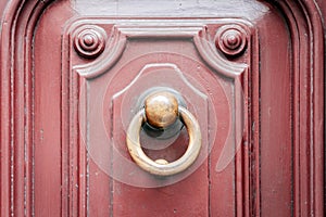 Exterior vintage door knocker metal circle on a door of an ancient building in Catania, Sicily, Italy