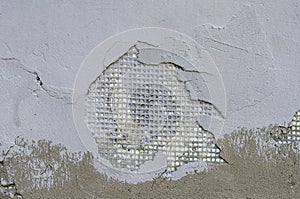 Exterior wall of a building with damaged stucco