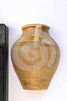 Exterior wall decoration of a greek house.Clay jug in a white wall of house. Mediterranean style. Corfu island, Greece