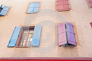 Shuttered windows in apartment building Narbonne, France.