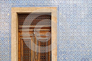 Exterior wall of a residential building with traditional portuguese tiles and entrance door in the Bairro Alto district in the old photo