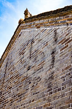 An exterior wall and roof of an ancient Chinese masonry building